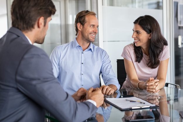 Mature smiling couple meeting financial advisor for investment a